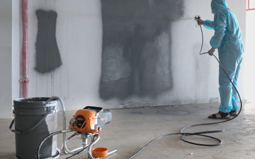 Professional comparing airless paint sprayer and traditional roller methods showing speed difference and finish quality on large wall surface