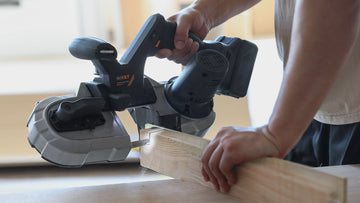 Professional vertical band saw cutting thick wood showing continuous blade and precision cutting capabilities for woodworking applications