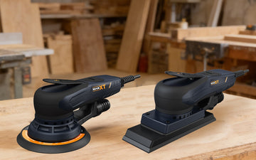 Orbital sander with round pad and palm sander with square pad side by side on woodworking bench